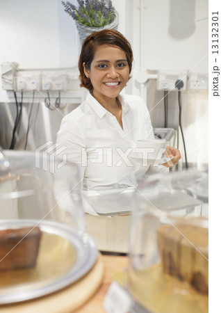 An Asian lady serving coffee. An Asian lady serving coffee. 13132301
