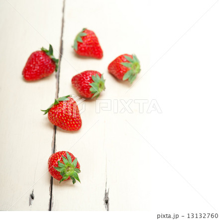fresh organic strawberry over white wood 13132760