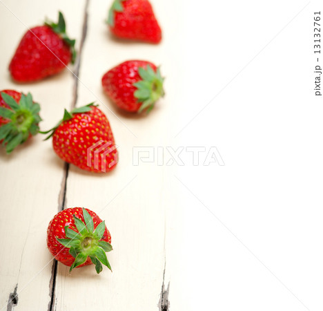 fresh organic strawberry over white wood 13132761