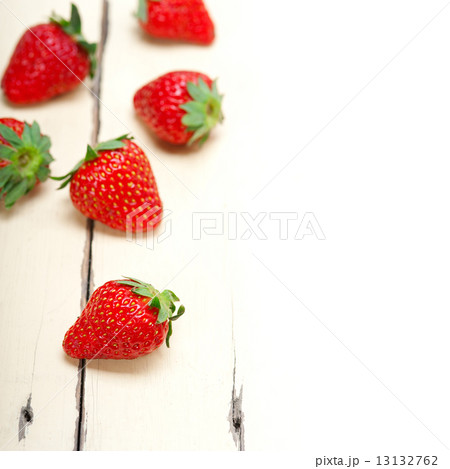 fresh organic strawberry over white wood 13132762