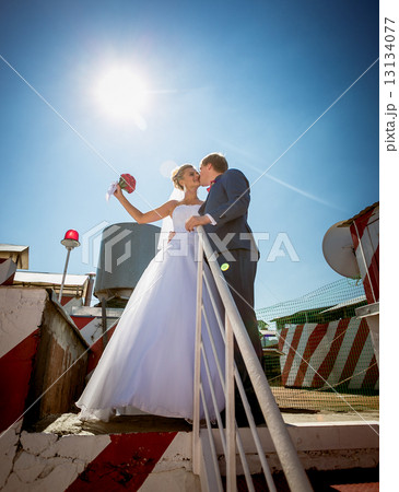 just married couple kissing on the roof top of skyscraper just married couple kissing on the roof top of skyscraper 13134077