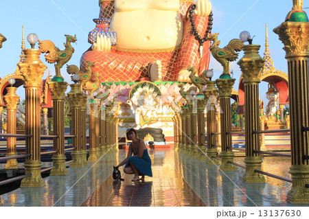 Woman at Smiling fat Buddha of wealth statue on Koh Samui, Thailand 13137630