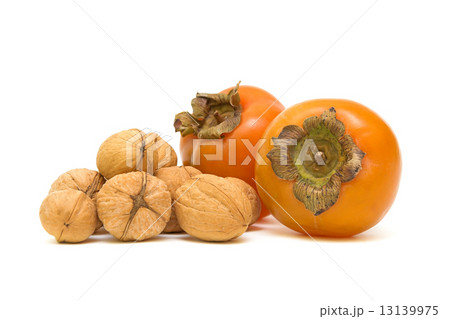 persimmons and walnuts on white background 13139975