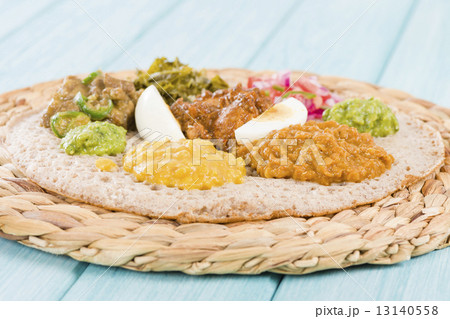 Ethiopian Feast - Injera with doro wat, yebeg alicha, misir wat, kik alicha, and gomen Ethiopian Feast - Injera with doro wat, yebeg alicha, misir wat, kik alicha, and gomen 13140558