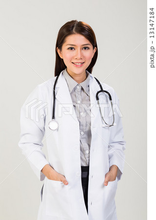 Pretty female doctor in white coat and stethoscope 13147184