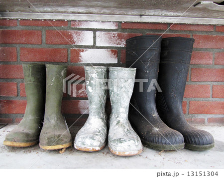 Rubber boots on the brick wall background 13151304