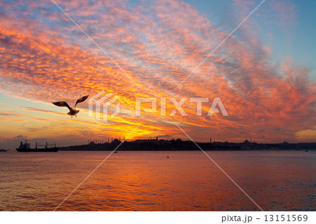 Sunset at Istanbul. Setting sun fired up the sky and Bosphorus waters 13151569