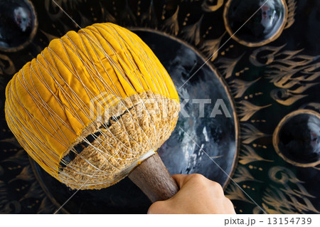 Hand hit big gong in temple  13154739