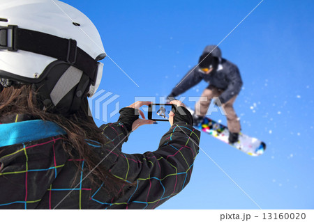 Photographed snowboarder jump with cell phone 13160020