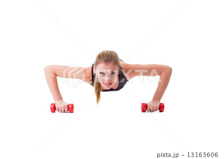 Smiling female athlete push-ups on dumbbells Smiling female athlete push-ups on dumbbells 13163606
