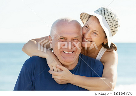 Happy mature couple against sea and sky 13164770