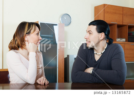 Serious couple talking in home 13165872