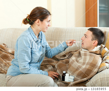 Girl giving medicament to unwell husband 13165955