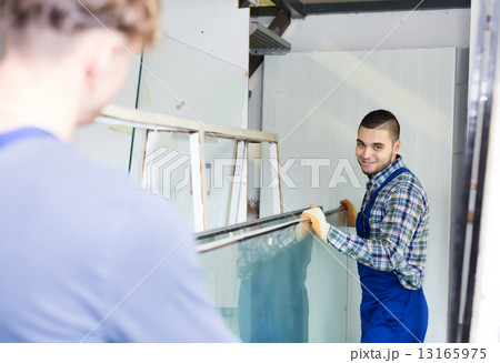 Two careful workmen working with glass Two careful workmen working with glass 13165975