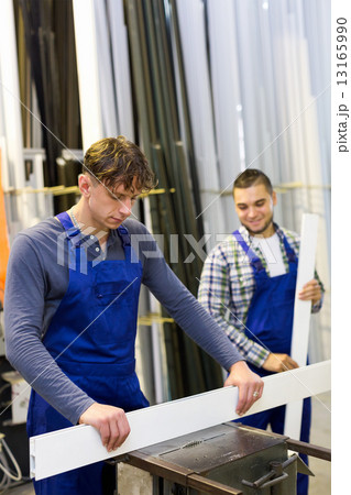 Workers cutting window profiles 13165990