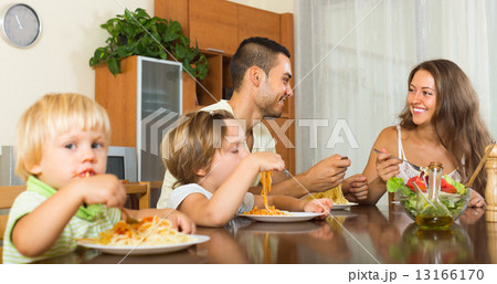 Family of four eating spaghetti 13166170