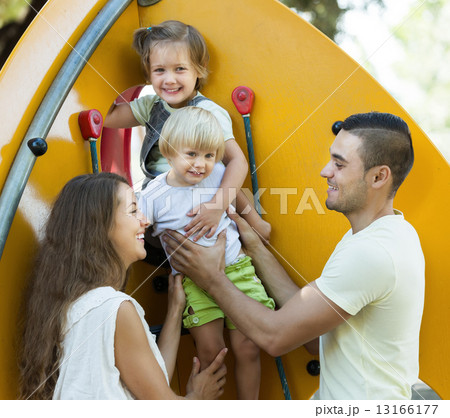Smiling parents helping children on stairs Smiling parents helping children on stairs 13166177