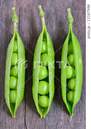 Fresh peas on wooden table Fresh peas on wooden table 13167996