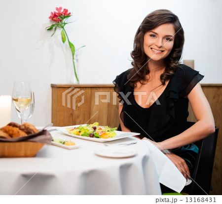 Beautiful young lady alone in restaurant 13168431