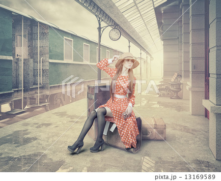 The girl sitting on the suitcase 13169589