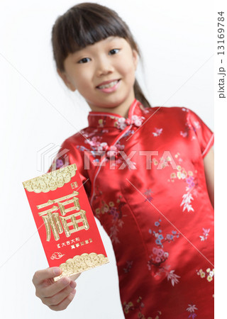 Close up of one young chinese girl in cheongsam holding a red packet in isolated white background 13169784