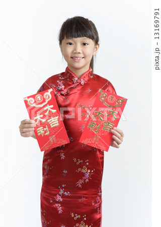 One young chinese girl in cheongsam holding 2 big red packets in isolated white background One young chinese girl in cheongsam holding 2 big red packets in isolated white background 13169791