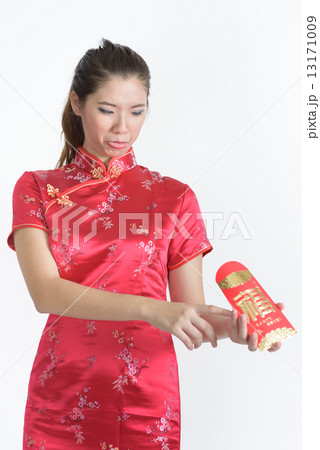1 young chinese woman in cheongsam unsatisfied at her red packet amount in isolated white background 1 young chinese woman in cheongsam unsatisfied at her red packet amount in isolated white background 13171009