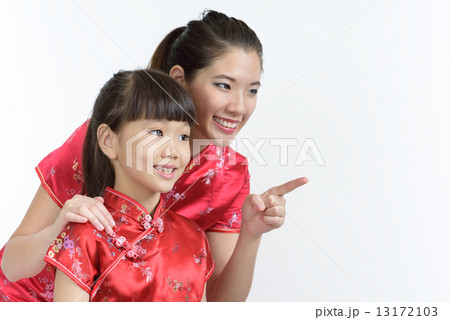 Young chinese mother and daughter looking pointing at lunar new year gifts isolated white background 13172103