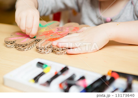 Little female baby painting with colorful paints 13173640