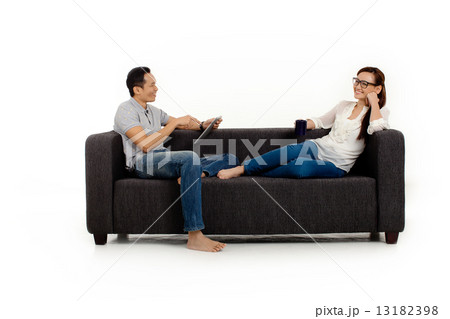 Asian Couple on Couch in White Background Asian Couple on Couch in White Background 13182398