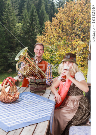 Young couple in traditional Bavarian clothes enjoy your leisure in common 13182967