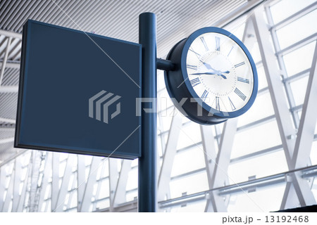 Clock at an international airport and sign 13192468