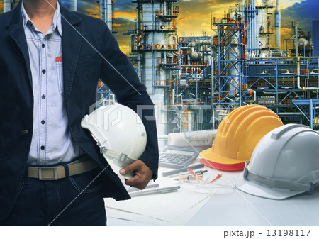 engineering man standing with white safety helmet against oil r engineering man standing with white safety helmet against oil r 13198117