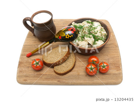 Russian pelmngi with meat on a cutting board isolated on white b 13204435
