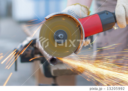 Sparks flying metal cutting abrasive disk. 13205992