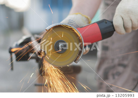 Worker cuts metal. 13205993