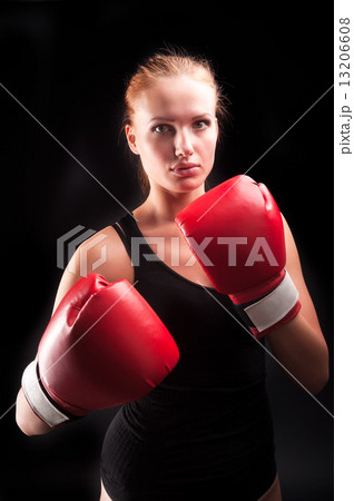 Beautiful girl defends in boxing gloves 13206608