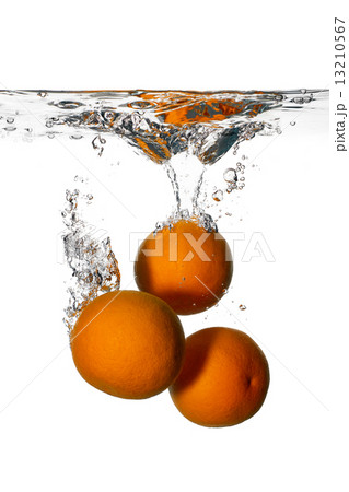 Fresh and Health Oranges Falling into Clean Water Isolated on Wh 13210567