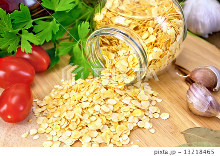 Pea flakes in jar with garlic on board Pea flakes in jar with garlic on board 13218465