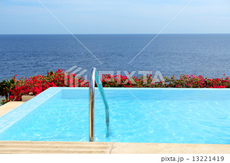 The infinity sea view swimming pool with jacuzzi at luxury hotel 13221419