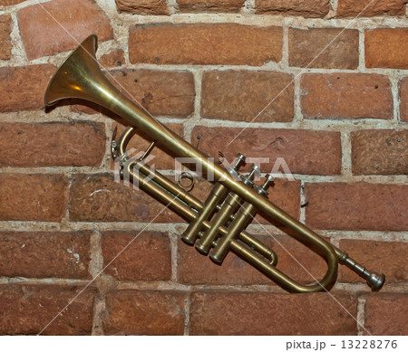 Trumpet on brick wall background Trumpet on brick wall background 13228276