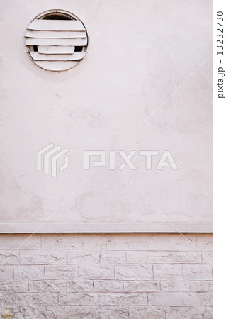 white brick wall with a hole for fan 13232730