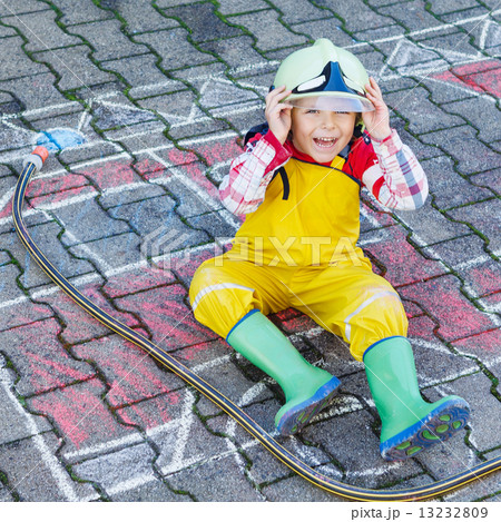 Funny adorable child of four years having fun with fire truck pi Funny adorable child of four years having fun with fire truck pi 13232809