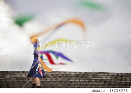 An artist during a performance moving a line of flags or streamers. An artist during a performance moving a line of flags or streamers. 13238578