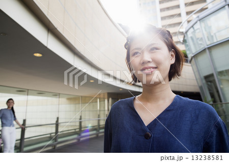 A woman on a walkway in Namba Park office and shopping complex. 13238581