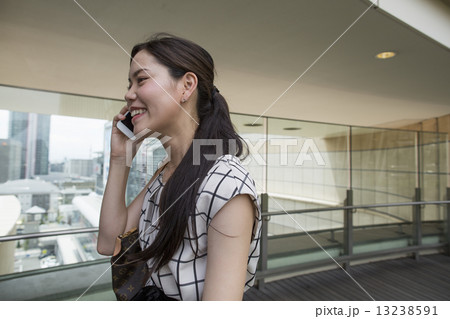 A woman on a walkway in Namba Park office and shopping complex. 13238591