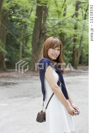 A woman in a Kyoto park posing for a photograph. A woman in a Kyoto park posing for a photograph. 13238592