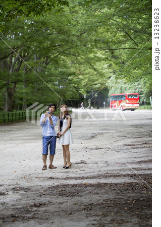 A couple, a man and woman in a Kyoto park. 13238623