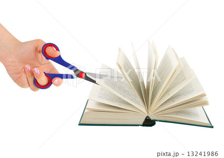Hand with scissors cutting book Hand with scissors cutting book 13241986