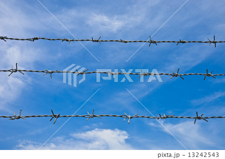 Barbed wires against blue sky. Barbed wires against blue sky. 13242543